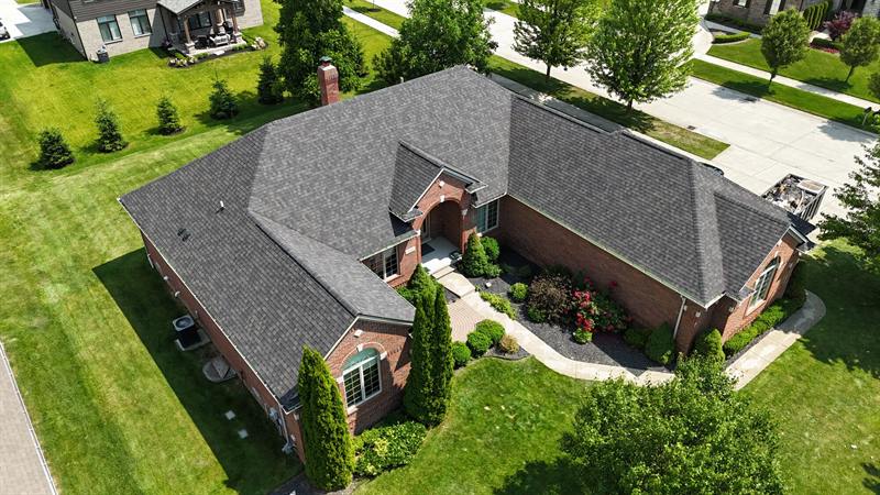 Brick home with a dark new roof